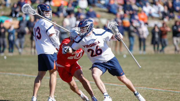 Griffin Schutz dodges with the ball during the Virginia men's lacrosse game against Ohio State at Klockner Stadium.